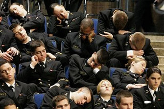 Naval Academy midshipmen sleep in their seats as they wait for President George Bush.