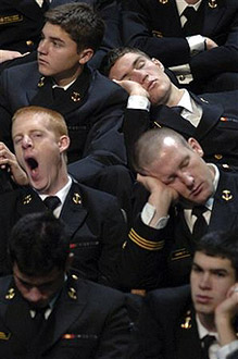 Naval Academy midshipmen sleep in their seats as they wait for President George Bush.