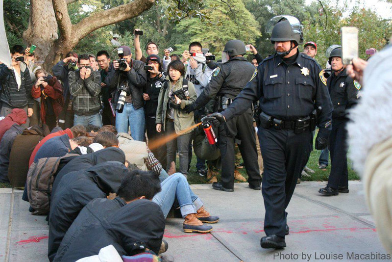 Louise Macabitas: Photo of Police Officer Pepper Spraying UC Davis Students